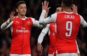Arsenal's German midfielder Mesut Ozil (L) celebrates scoring his team's fifth goal with Arsenal's Spanish defender Hector Bellerin (C) and Arsenal's Spanish striker Lucas Perez during the UEFA Champions League Group A football match between Arsenal and Ludogorets Razgrad at The Emirates Stadium in London on October 19, 2016. / AFP / BEN STANSAL(Photo credit should read BEN STANSALL/AFP/Getty Images)