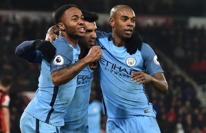 Manchester City's Argentinian striker Sergio Aguero (C) celebrates with Manchester City's English midfielder Raheem Sterling and Manchester City's Brazilian midfielder Fernandinho (R) after scoring their second goal during the English Premier League football match between Bournemouth and Manchester City at the Vitality Stadium in Bournemouth, southern England on February 13, 2017. / AFP PHOTO / Glyn KIRK / RESTRICTED TO EDITORIAL USE. No use with unauthorized audio, video, data, fixture lists, club/league logos or 'live' services. Online in-match use limited to 75 images, no video emulation. No use in betting, games or single club/league/player publications.  /
